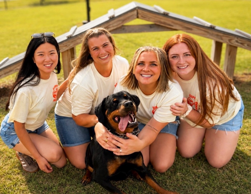 The Happy Hoomans Pet Care team with a happy dog